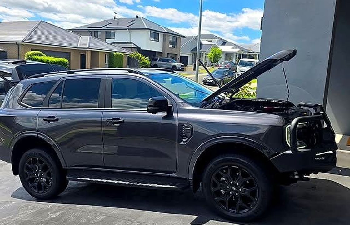 Hot Wired Installations working on a 4WD in a customer driveway